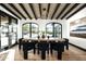 Dining room features high ceilings, arched windows, designer lighting, and wood floors at 19978 N 101St Pl, Scottsdale, AZ 85255