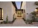 Inviting walkway to home featuring professional landscaping and an iron grid entry door at 19978 N 101St Pl, Scottsdale, AZ 85255