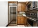 A modern kitchen showcasing stainless steel Viking appliances and a built-in wine cooler at 19978 N 101St Pl, Scottsdale, AZ 85255