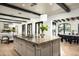 Bright open kitchen with an island featuring a stone countertop and a sink at 19978 N 101St Pl, Scottsdale, AZ 85255