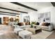 Spacious living room featuring a neutral palette, beamed ceilings, open layout, and views of the kitchen at 19978 N 101St Pl, Scottsdale, AZ 85255