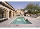 Inviting backyard pool area with a travertine patio, a built-in spa, and an outdoor kitchen at 19978 N 101St Pl, Scottsdale, AZ 85255