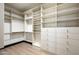 Walk-in closet featuring custom shelving and drawers for maximum storage and organization at 19978 N 101St Pl, Scottsdale, AZ 85255