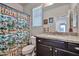 Beach themed bathroom featuring a vanity with a granite countertop and a tropical themed shower curtain at 20231 W Grant St, Buckeye, AZ 85326