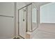 Bathroom with an enclosed shower, tub with white tile, and modern fixtures complimented with natural light at 20231 W Grant St, Buckeye, AZ 85326