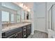 Bathroom boasts double sinks, granite counters, and a framed glass shower showcasing a clean, modern aesthetic at 20231 W Grant St, Buckeye, AZ 85326