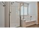 Bright bathroom featuring an enclosed shower, a soaking tub, and modern finishes accented by natural light at 20231 W Grant St, Buckeye, AZ 85326