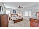 Spacious bedroom featuring a decorative ceiling fan, pendant lights, and a wooden dresser at 20231 W Grant St, Buckeye, AZ 85326