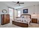 Cozy bedroom with a wooden bed, sliding barn door to the bathroom and pendant lights at 20231 W Grant St, Buckeye, AZ 85326