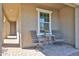 Cozy front porch seating area with a table and chairs, creating a welcoming entrance at 20231 W Grant St, Buckeye, AZ 85326