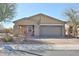 Charming home exterior featuring a well-maintained front yard and attached garage at 20231 W Grant St, Buckeye, AZ 85326