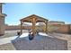 Patio with rock landscaping featuring a charming pergola and outdoor dining set at 20231 W Grant St, Buckeye, AZ 85326