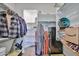 Spacious walk-in closet featuring open shelving for storage, metal rods for hanging clothes, and carpeted floors at 20231 W Grant St, Buckeye, AZ 85326