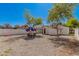 Backyard featuring a gravel area with patio furniture, string lights, and a white fence at 2032 E Harvard St, Phoenix, AZ 85006