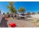 The backyard has a graveled area, patio table, string lights and a white fence at 2032 E Harvard St, Phoenix, AZ 85006