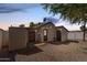 Private backyard area with gravel landscaping, string lights, and access to storage sheds at 2032 E Harvard St, Phoenix, AZ 85006