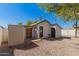 A view of a backyard with a white house, gravel, storage and string lights at 2032 E Harvard St, Phoenix, AZ 85006