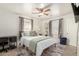 Bright bedroom with a ceiling fan, a window, light walls and wood-style flooring at 2032 E Harvard St, Phoenix, AZ 85006