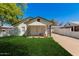 Charming single-story home with a covered front porch, well-maintained lawn, and covered parking at 2032 E Harvard St, Phoenix, AZ 85006