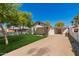 Charming single-story home with a covered front porch, well-maintained lawn, and covered parking at 2032 E Harvard St, Phoenix, AZ 85006