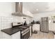 Well-lit kitchen featuring white subway tile, white cabinets and stainless steel appliances at 2032 E Harvard St, Phoenix, AZ 85006