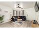 Cozy living room with sleek furniture, a ceiling fan, and wood flooring at 2032 E Harvard St, Phoenix, AZ 85006