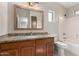 Bathroom with granite countertop vanity, a toilet, and a shower-tub combo with white tile surround at 2150 E Bell Rd # 1176, Phoenix, AZ 85022