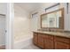 Bathroom featuring granite countertop vanity, and a shower-tub combo with white tile surround at 2150 E Bell Rd # 1176, Phoenix, AZ 85022