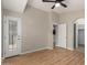 Bright bedroom with light wood flooring, ceiling fan, and a door to the outside at 2150 E Bell Rd # 1176, Phoenix, AZ 85022