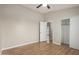 Bedroom with light wood flooring and fan, featuring access to closet and natural light at 2150 E Bell Rd # 1176, Phoenix, AZ 85022