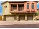 A three-car garage beneath a two-story condo with brick driveway at 2150 E Bell Rd # 1176, Phoenix, AZ 85022