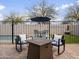 Backyard seating area with a fire pit, chairs, and a view of the pool at 22336 E Via Del Palo --, Queen Creek, AZ 85142