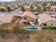 Aerial view of the home's backyard featuring a swimming pool, patio furniture, and privacy fencing at 22336 E Via Del Palo --, Queen Creek, AZ 85142