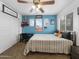 Cozy bedroom with blue accent wall and ceiling fan at 22336 E Via Del Palo --, Queen Creek, AZ 85142