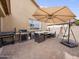 Spacious backyard patio with a full outdoor kitchen and a cozy hammock at 22336 E Via Del Palo --, Queen Creek, AZ 85142