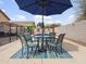 Backyard poolside featuring outdoor dining furniture under an umbrella at 22336 E Via Del Palo --, Queen Creek, AZ 85142