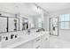 Bright bathroom features double sinks, a large mirror, and a closet in the corner of the bathroom at 22484 E Twilight Dr, Queen Creek, AZ 85142