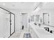 Bright bathroom features double sinks, a large mirror, and a modern walk-in shower with black trim at 22484 E Twilight Dr, Queen Creek, AZ 85142
