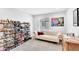 Large walk-in closet includes shoe racks, a couch, and a window offering natural light and a painting at 22484 E Twilight Dr, Queen Creek, AZ 85142