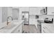 Modern kitchen with stainless steel appliances, white countertops, and gold hardware accents at 22484 E Twilight Dr, Queen Creek, AZ 85142