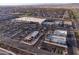 Aerial view of a shopping center with stores, parking, and surrounding neighborhoods at 24117 N 165Th Dr, Surprise, AZ 85387