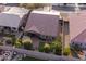 Aerial view of a private backyard with a covered patio, verdant landscaping, and ample space for outdoor entertaining at 24117 N 165Th Dr, Surprise, AZ 85387