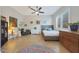 Bright bedroom featuring tile floors, a ceiling fan, and natural light from a large window at 24117 N 165Th Dr, Surprise, AZ 85387