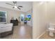 Bright bedroom featuring a ceiling fan, tile floors, a dresser and a wall-mounted TV at 24117 N 165Th Dr, Surprise, AZ 85387