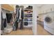 Walk-in closet with shelves, hanging racks, and a washer and dryer at 24117 N 165Th Dr, Surprise, AZ 85387