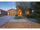 Inviting single-story home with a stone-accented entrance, desert landscaping, and a cozy, welcoming feel at 24117 N 165Th Dr, Surprise, AZ 85387