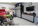 Organized garage with epoxy floors, storage cabinets, tool chests, and a flat-screen TV for an entertaining space at 24117 N 165Th Dr, Surprise, AZ 85387