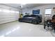 Organized garage with epoxy flooring, showcasing ample space for parking and storage at 24117 N 165Th Dr, Surprise, AZ 85387