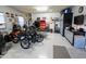 Well-organized garage with various vehicles, equipment, and built-in storage, maximizing space and utility at 24117 N 165Th Dr, Surprise, AZ 85387