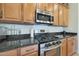 This kitchen has stainless steel appliances and wooden cabinets at 24117 N 165Th Dr, Surprise, AZ 85387